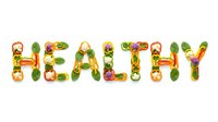 Word HEALTHY spelled with colorful fresh vegetables and greens on white background, promoting nutrition and wellness lifestyle.