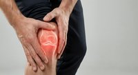 Man holding knee with red highlighted pain area showing joint inflammation and arthritis symptoms for medical healthcare concept.