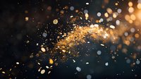 Golden glitter explosion with sparkling particles against dark background creates magical atmosphere for festive designs and luxury advertising concepts.