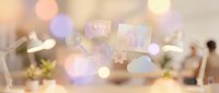 Blurred office workspace with floating digital icons and bokeh lights, representing cloud computing, data storage, and modern technology solutions for business applications.