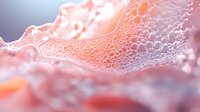 Delicate coral pink soap bubbles create abstract macro texture with soft light and shadows, showcasing intricate patterns and translucent surfaces for beauty and cosmetic designs.