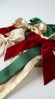 Festive holiday ribbons in red, green and gold colors with elegant bows for Christmas gift wrapping and seasonal decoration projects.