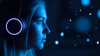 Young blonde woman in profile with futuristic blue lighting and glowing particles, sci-fi technology concept for digital innovation and future themes.