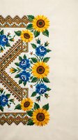 Traditional Ukrainian embroidery pattern with sunflowers and blue roses on beige fabric background for cultural textile design projects.