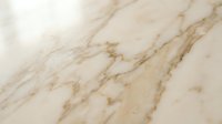 Elegant beige marble surface with natural golden veining patterns for luxury interior design and architectural applications.