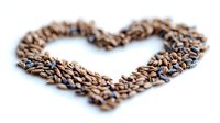 Coffee beans arranged in heart shape on white background, selective focus with blurred edges creates romantic mood for cafe and restaurant designs.