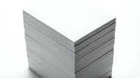 Stack of blank white papers or cards isolated on white background, ready for design mockups, printing projects, and corporate branding applications.