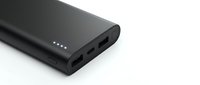 Black portable power bank with multiple USB ports and LED indicators on white background isolated for electronic device charging solutions.