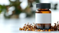 Label surrounded by scattered golden vitamin capsules and dried herbs on white surface. Medical supplement concept.