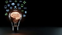 Light bulb with glowing brain inside surrounded by technology icons on dark background representing artificial intelligence and innovation concepts.