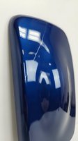 Glossy deep blue automotive side mirror cover with metallic finish reflecting light on neutral background for car customization and repair projects.