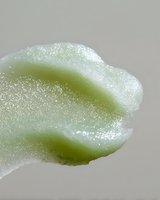 Macro photography of light green organic shape with delicate crystalline texture and soft curves against neutral background, showcasing natural frost-like surface detail.