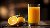 Fresh orange juice in glass with sliced oranges on wooden table, healthy breakfast drink rich in vitamin C for morning nutrition and wellness lifestyle.