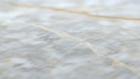 White marble surface with natural gold veining patterns and luxurious stone texture for elegant interior design and architectural applications.