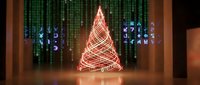 Futuristic Christmas tree made of glowing red light trails in digital matrix environment with green code background for holiday technology concepts.