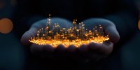 Glowing miniature cityscape held in cupped hands against dark background, illuminated skyscrapers and buildings creating magical urban scene at night.