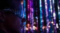 Young Asian woman profile silhouette against glowing bokeh lights background in blue and purple colors creating magical nighttime atmosphere. Dreamy mood concept.