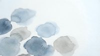 Abstract watercolor paint blobs in blue and gray tones on white paper background for artistic design projects and creative layouts.