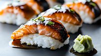 Grilled salmon nigiri sushi with rice and wasabi paste on dark background, selective focus on fresh fish with crispy skin and garnished with green onions.