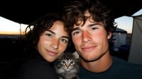 Young couple with adorable kitten enjoying outdoor camping adventure at sunset, creating memories together in nature with their pet companion.