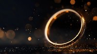 Glowing golden ring with magical sparkles and bokeh effects on dark background creates mystical atmosphere for wedding and engagement designs.