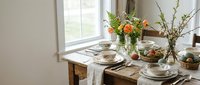 Rustic wooden dining table set for spring brunch with fresh flowers, ceramic plates, and natural light streaming through window for home decor inspiration.