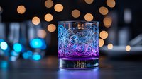 Glowing cocktail glass with ornate swirl pattern illuminated by purple and blue lights against blurred golden bokeh background creates magical atmosphere.