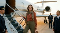 Professional businesswoman in casual attire disembarking private jet with crew and security personnel at luxury airport terminal during golden hour.