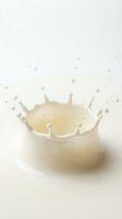 Milk splash crown with droplets on white background creating dynamic liquid motion for dairy and beverage advertising campaigns.