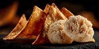 Artisanal bread slices and lion's mane mushroom on dark slate surface with warm lighting creating rustic culinary composition for gourmet cooking concepts.