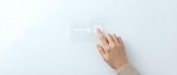 Hand touching transparent glass surface with fingerprints visible on clean modern interface for technology and interaction concepts.