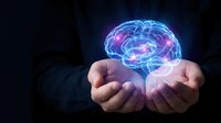 Businessman hands holding glowing digital brain with neural networks on dark background representing artificial intelligence and innovation concepts.