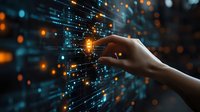 Female hand touching glowing digital network with orange and blue light particles, representing technology connectivity and future innovation.