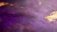 Luxurious purple and gold abstract macro background with metallic texture and soft focus effect creates elegant artistic surface for luxury designs.