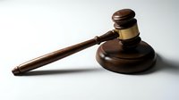 Wooden judge gavel with brass band on white background for legal concepts, courtroom proceedings, justice system and law firm presentations.