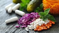 Colorful probiotics and fermented vegetables with vitamin supplements on dark stone background, healthy gut microbiome and digestive wellness concept.