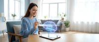 Young woman using laptop with holographic brain projection in modern home office workspace for neuroscience technology research and artificial intelligence development.