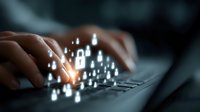 Businessman hands typing on laptop keyboard with glowing digital security lock icons representing cybersecurity and data protection technology.