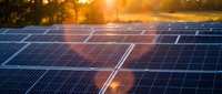 Solar panels gleaming in golden sunset light with warm bokeh background creating sustainable energy concept for environmental and renewable power projects.