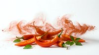 Fresh red chili peppers with vibrant spice powder explosion on white background, capturing heat and bold flavor for food and culinary concepts.