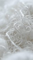 Translucent tangled fibers with crystalline formations create an ethereal, delicate texture in soft focus. Use for wellness, skincare, cosmetics, and luxury product backgrounds.
