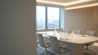 Modern conference room with wooden wall paneling, floor-to-ceiling windows overlooking cityscape, long white table, ergonomic chairs, and ambient ceiling lighting for corporate meetings.