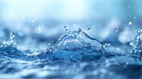 Dynamic water splash with crown-shaped droplets creating artistic formation against blurred blue background, macro photography capturing liquid motion and transparency.