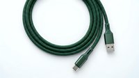 Green braided USB charging cable coiled neatly on white background, showing USB-A and USB-C connectors for tech and electronics use.