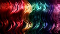 Vibrant wavy rainbow hair strands flowing in smooth curves across dark background, featuring red, orange, yellow, turquoise, blue and purple colors for beauty and fashion design.