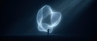 Silhouette of person standing before glowing abstract light form, representing innovation, imagination, and spiritual awakening for creative projects.