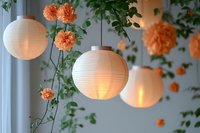 Glowing paper lanterns with climbing peach carnations create romantic garden atmosphere, soft illumination through white spherical shades amid green foliage.