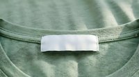 Green cotton t-shirt with blank white label tag at neck collar, mockup template for clothing brand design and apparel manufacturing concepts.