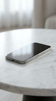 Modern smartphone with black screen lying on white marble table in bright minimalist interior for technology and communication concepts.