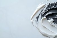 Black and white acrylic paint swirls mixing together creating abstract fluid art texture on light background for creative design projects.